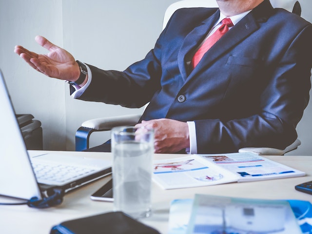 property managers in a dark suit sitting at their desk